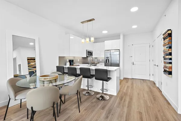 a view of a dining room with furniture and wooden floor