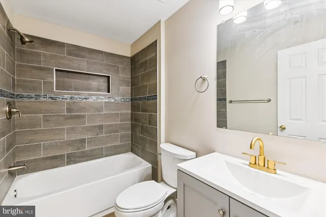 a bathroom with a sink a toilet and bathtub