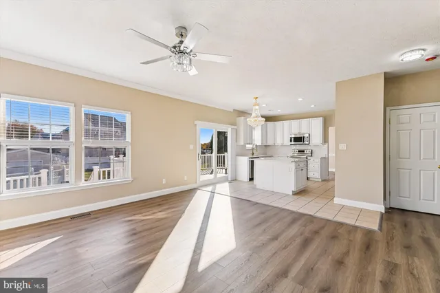 a view of a kitchen with wooden floor and a kitchen