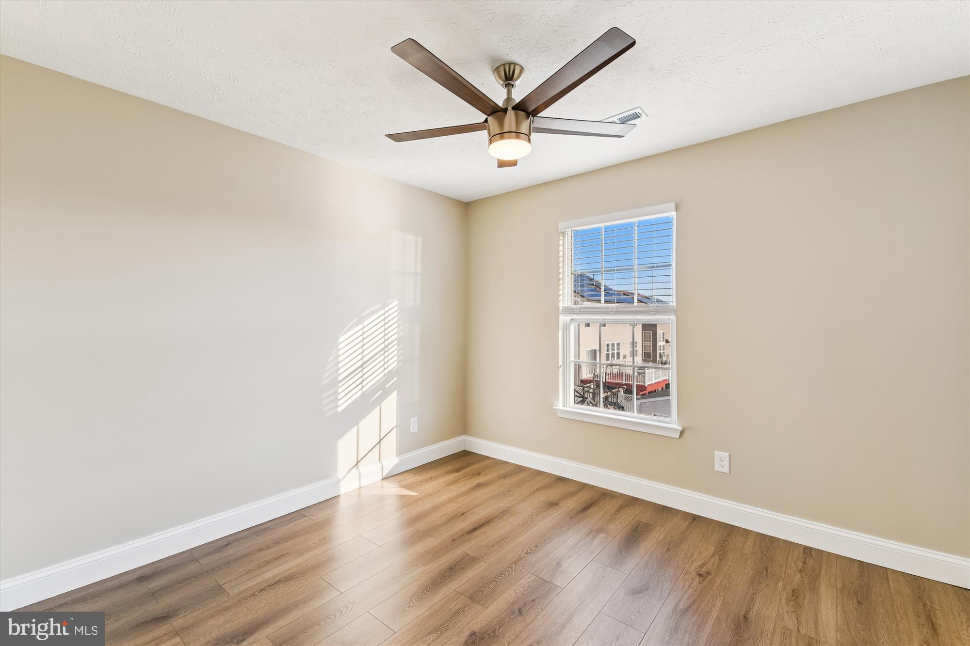 1375 Tralee Circle Aberdeen, MD 21001 - Photo 27 of 41 an empty room with wooden floor ceiling fan and windows
