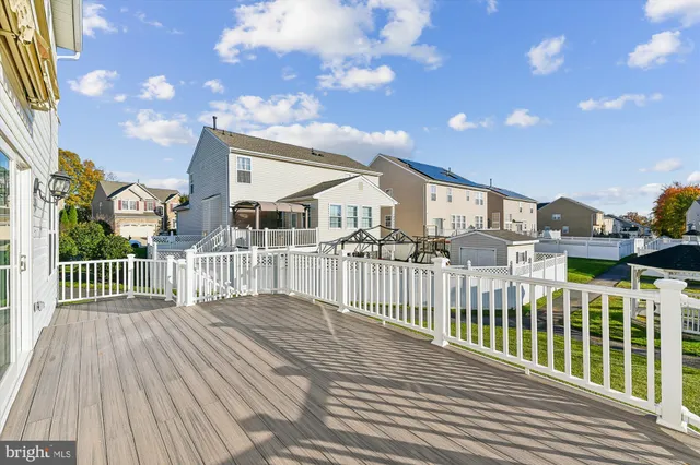 a view of a house with a wooden deck