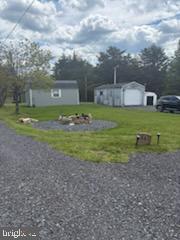 342 Big Maple Lane Schellsburg, PA 15559 - Photo 25 of 27 a view of a big house with a big yard and large trees
