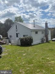 342 Big Maple Lane Schellsburg, PA 15559 - Photo 3 of 27 a backyard of a house with table and chairs