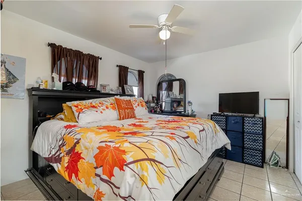 a bedroom with bed and a flat screen tv