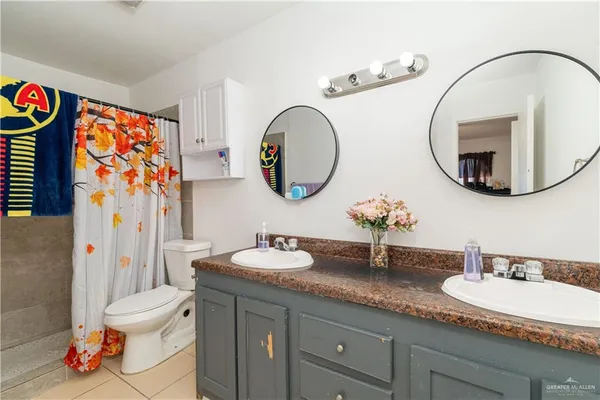 a bathroom with a toilet a sink and a mirror