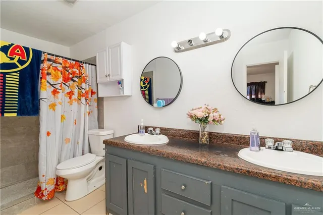 a bathroom with a toilet a sink and a mirror