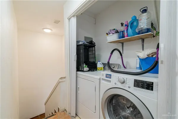 a view of storage and utility room with washer and dryer