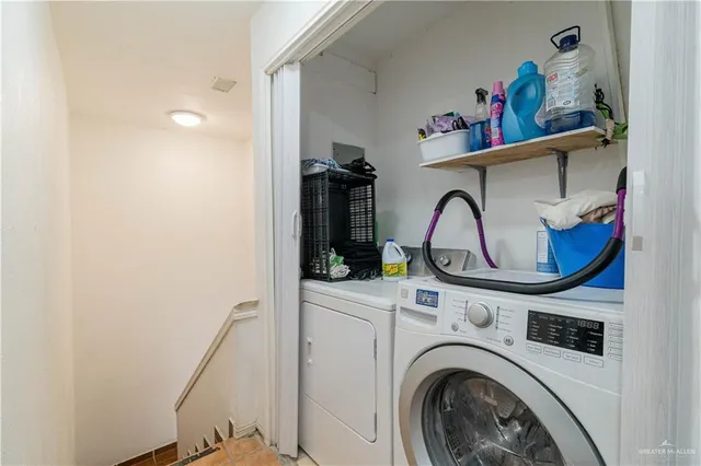 a view of storage and utility room with washer and dryer
