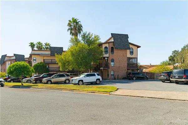 a view of swimming pool with outdoor seating and house in the background