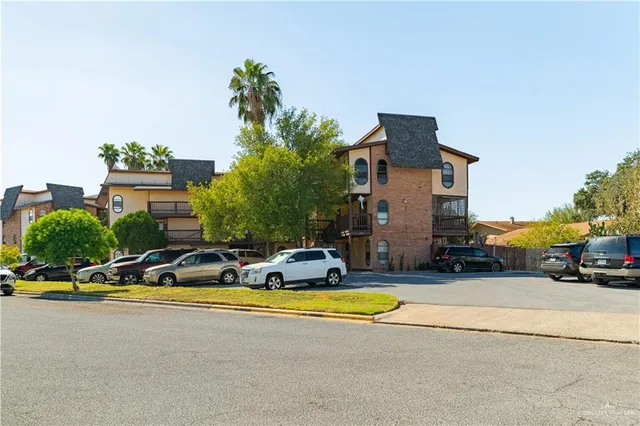 a view of swimming pool with outdoor seating and house in the background