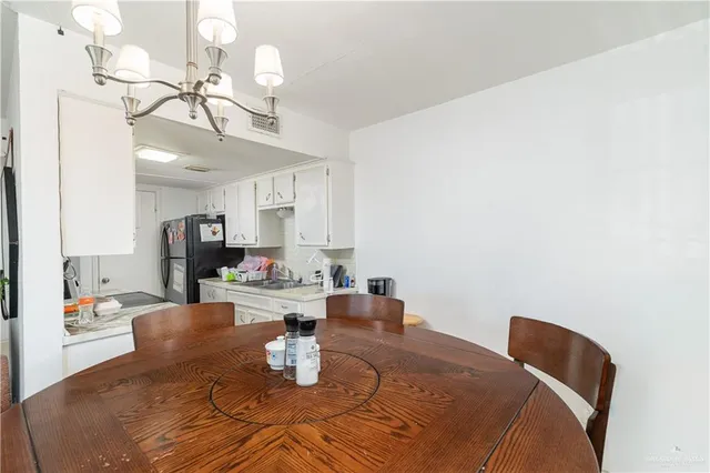 a dining room with table and chairs