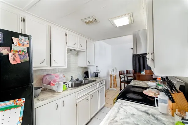 a kitchen with a sink stove and cabinets