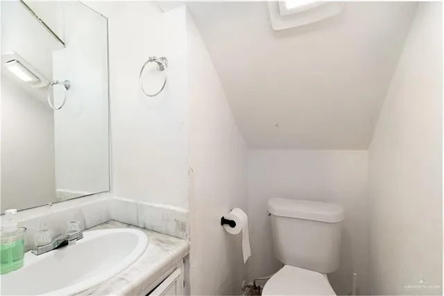 a white toilet sitting next to a bathroom sink