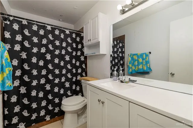 a bathroom with a sink toilet and mirror