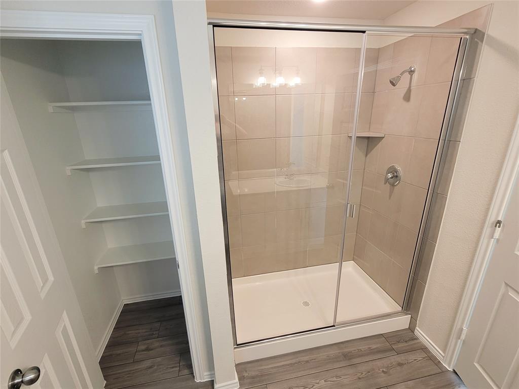 1049 Knightly Lane Haslet, TX 76052 - Photo 11 of 19 a bathroom with a glass shower door