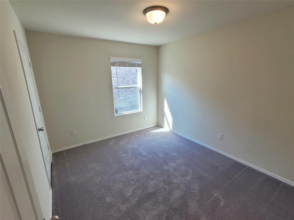 1049 Knightly Lane Haslet, TX 76052 - Photo 13 of 19 an empty room with windows
