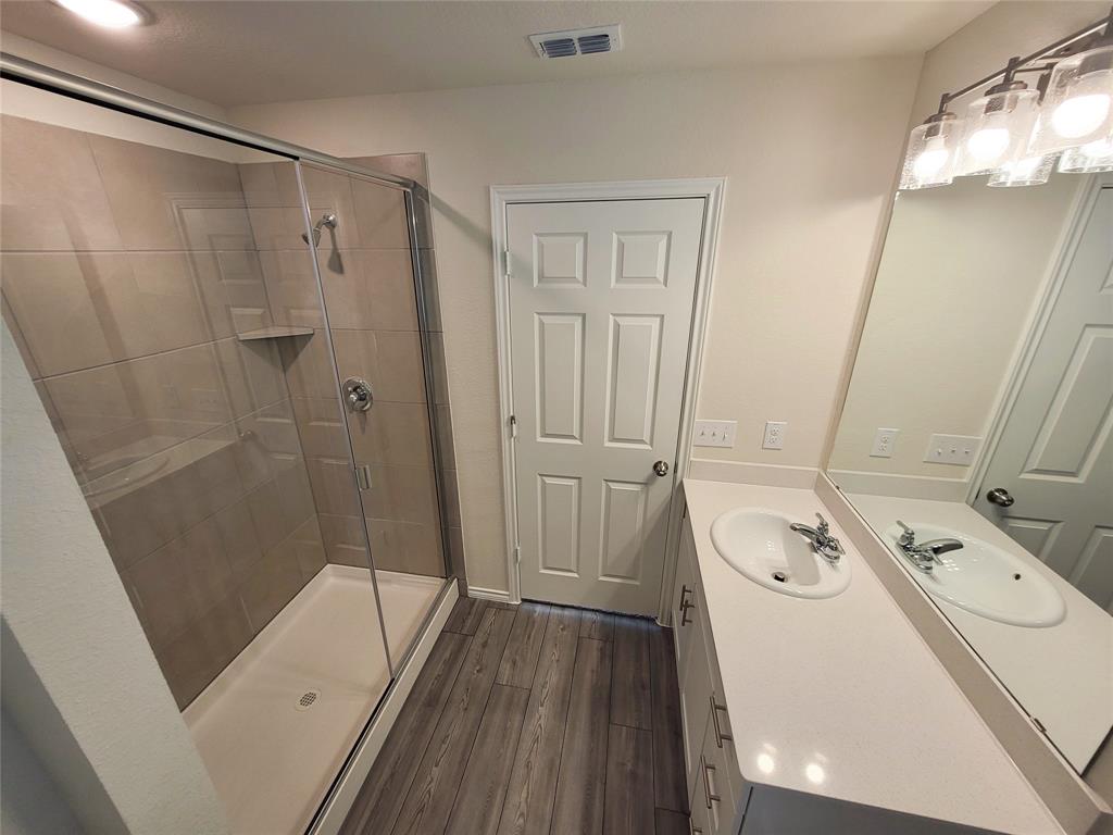 1049 Knightly Lane Haslet, TX 76052 - Photo 10 of 19 a bathroom with a tub a sink and a mirror