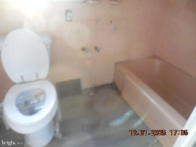 a white toilet sitting next to a white cabinet