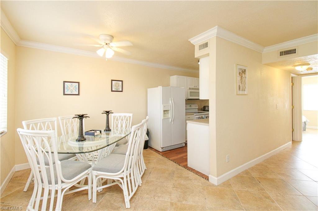 4615 Bayshore Drive, Unit E4 Naples, FL 34112 - Photo 13 of 30 a view of a dining room with furniture and a kitchen view