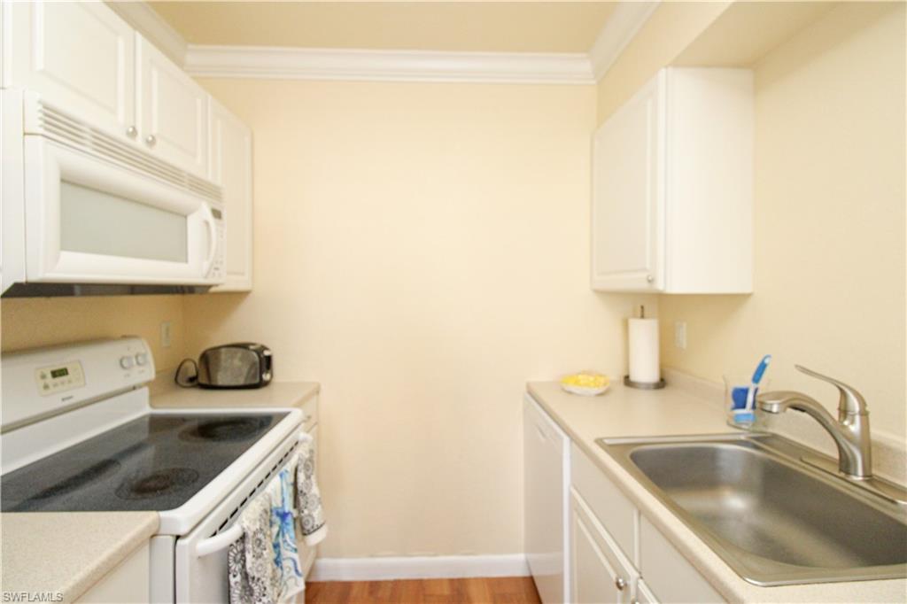 4615 Bayshore Drive, Unit E4 Naples, FL 34112 - Photo 15 of 30 a kitchen with a sink and cabinets