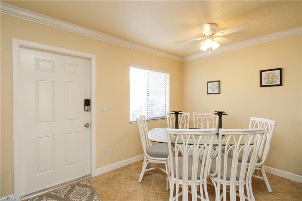 4615 Bayshore Drive, Unit E4 Naples, FL 34112 - Photo 6 of 30 a view of a dining room with furniture and wooden floor