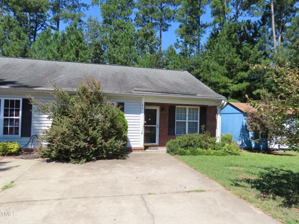 a view of a house with garden and plants