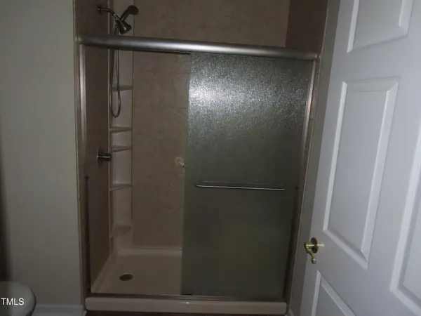 an empty room with wooden floor and a window