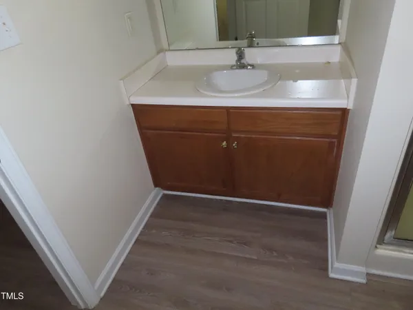 a white toilet sitting next to a shower