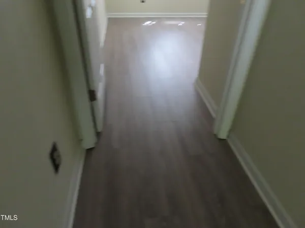 a view of a room with wooden floor