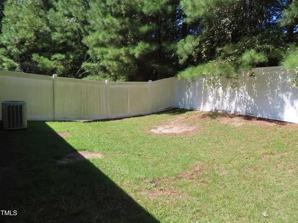a view of a yard with large trees