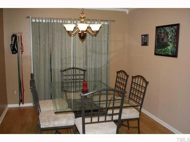 The dining room features laminate flooring, crown molding, and a sliding glass door which opens to the spacious deck. Dining Room