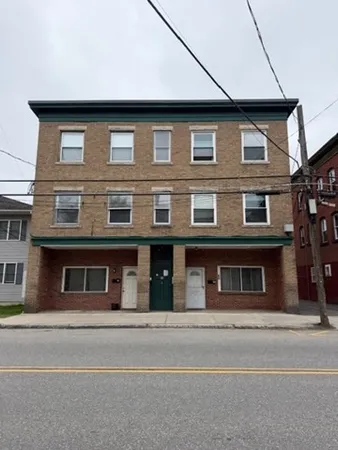a tall brick building with large windows