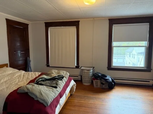 a bedroom with bed and a window