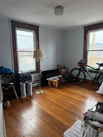 a living room with furniture window and wooden floor