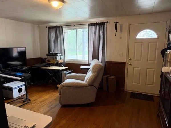 a livingroom with workspace and a couch