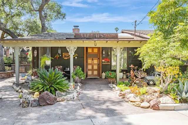 a view of a patio with a table and chairs under an umbrella