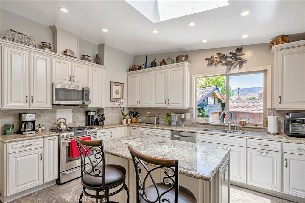 1126 Katherine Road Simi Valley, CA 93063 - Photo 12 of 66 a kitchen with stainless steel appliances kitchen island granite countertop a sink and cabinets