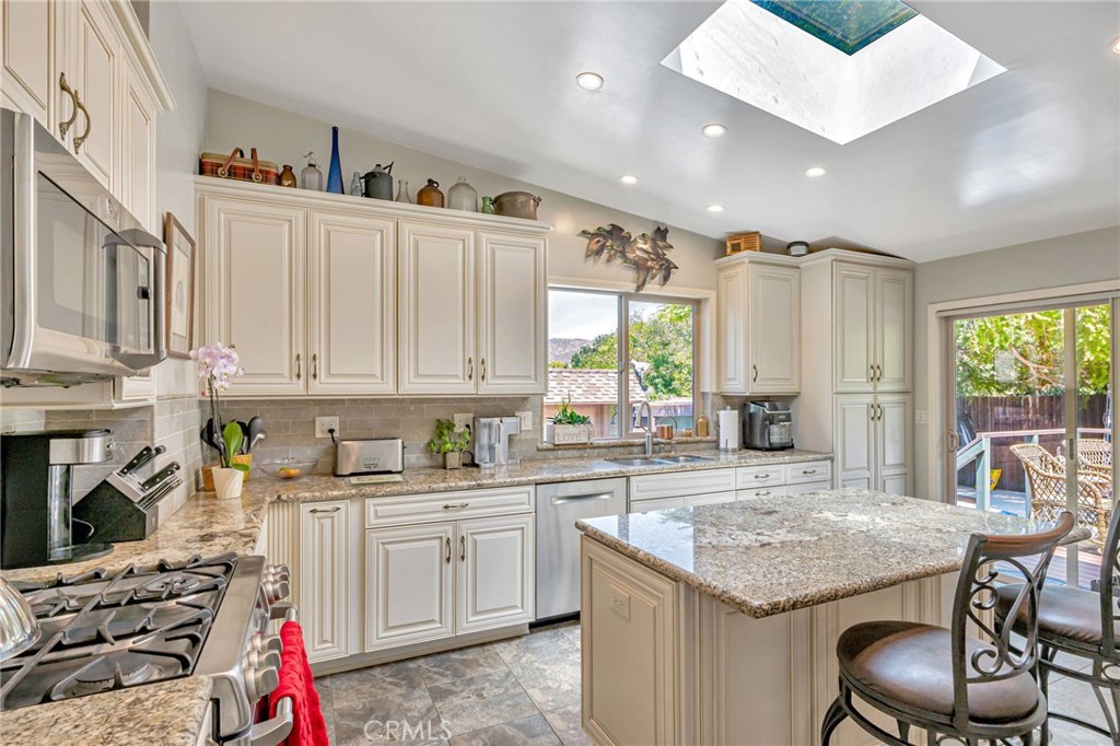 1126 Katherine Road Simi Valley, CA 93063 - Photo 13 of 66 a kitchen that has a lot of cabinets in it and appliances