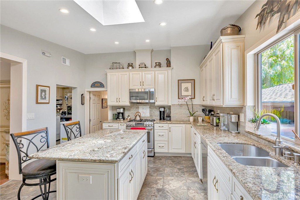 1126 Katherine Road Simi Valley, CA 93063 - Photo 15 of 66 a kitchen with stainless steel appliances granite countertop a sink stove and cabinets