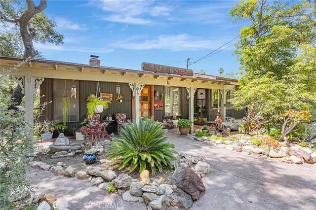 a view of a porch with plants and floor to ceiling window