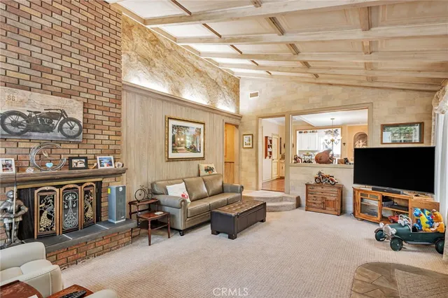 a living room with furniture a dining table and paintings on the wall