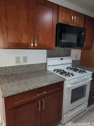 a kitchen with a stove and a microwave