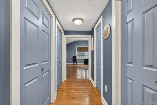 a view of a hallway view with wooden floor and staircase