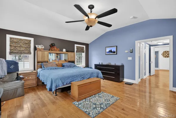a bedroom with a bed dresser and a window