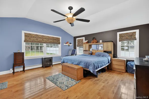 a spacious bedroom with a bed and window