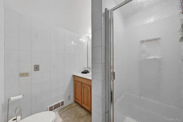 a bathroom with a granite countertop bathtub shower and toilet