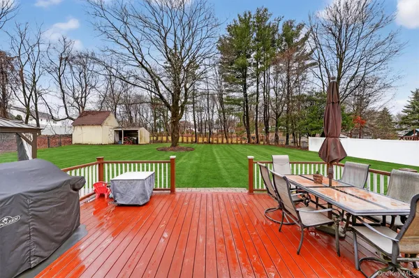a view of a deck with table and chairs and wooden floor