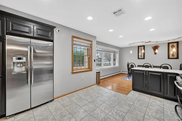 a view of kitchen with stainless steel appliances granite countertop a refrigerator and a sink
