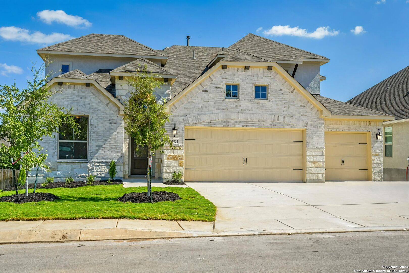 a front view of a house with a yard and garage