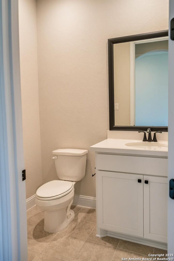 29354 Cheyenne Ridge Fair Oaks Ranch, TX 78015 - Photo 7 of 14 a bathroom with a sink a toilet and mirror